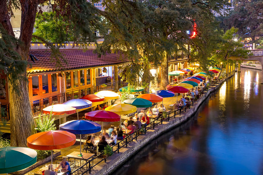 Vibrant scene at the San Antonio Riverwalk with people enjoying the view